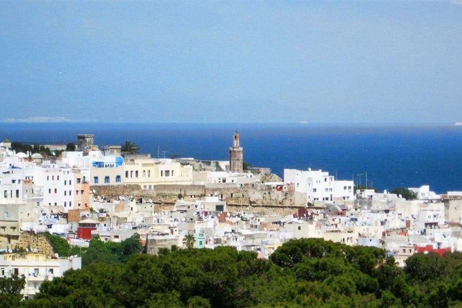 Vista panorámica de la medina de Tánger con edificios blancos y el Estrecho de Gibraltar,